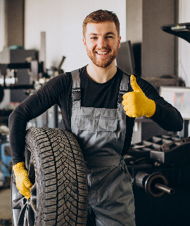 Mechanic with Tire Thumbs Up